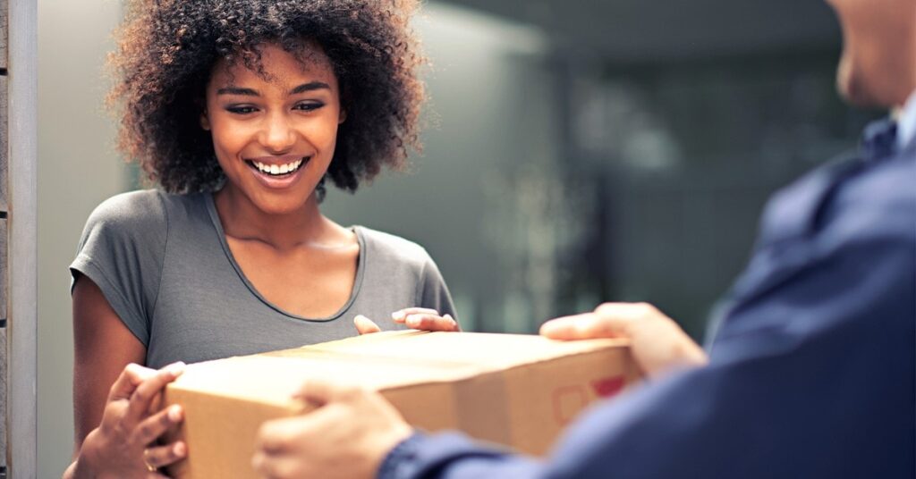 woman accepting package from delivery person