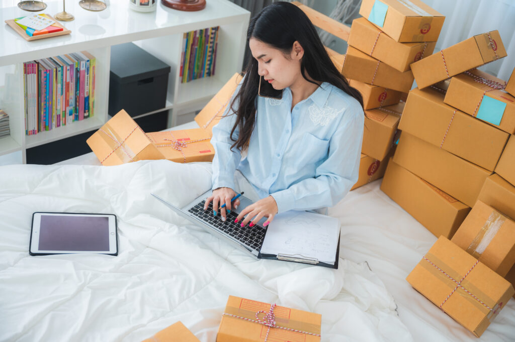 female packing the parcel order for online delivery service business