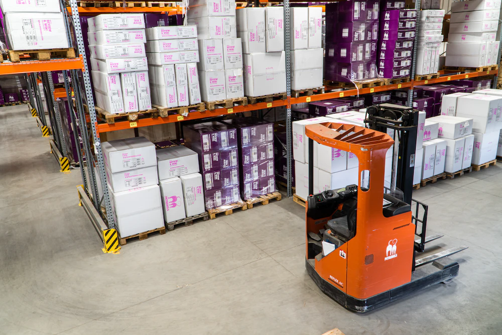fulfillment center with forklift parked in aisle