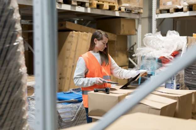 warehouse employee performing ecommerce order fulfillment for fitness products